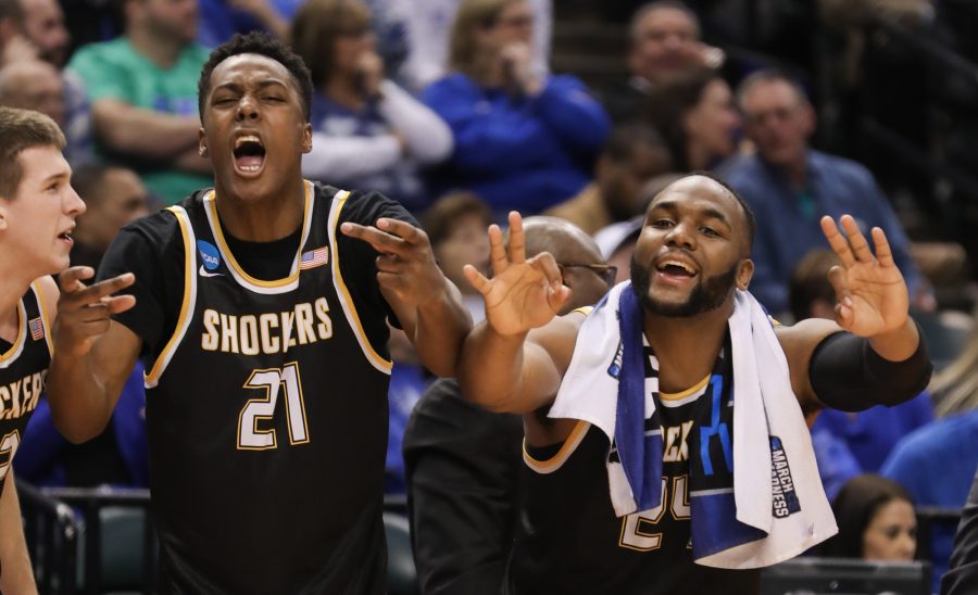 Wichita State’s Darral Willis (21) and Shaquille Morris (24) celebrate a teammate’s three-point bucket against Dayton in the second half at Bankers Life Fieldhouse in Indianapolis. (Mar. 17, 2017)