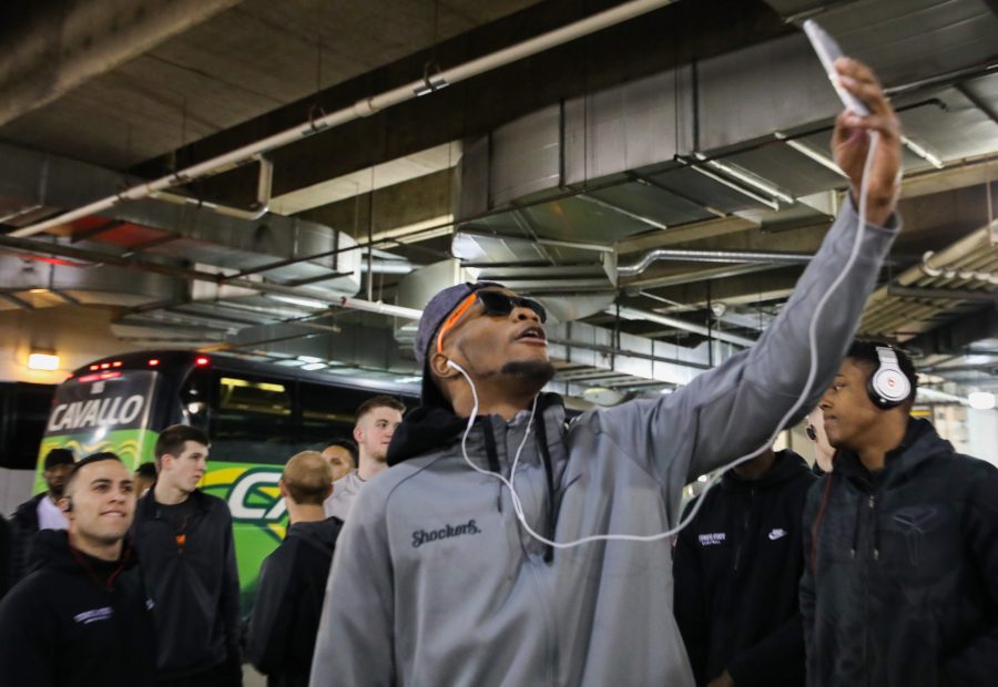 Wichita State’s Markis McDuffie Snapchats on his phone while entering Bankers Life Fieldhouse in Indianapolis on Friday afternoon before the NCAA Tournament game against Dayton. (Mar. 17, 2017)