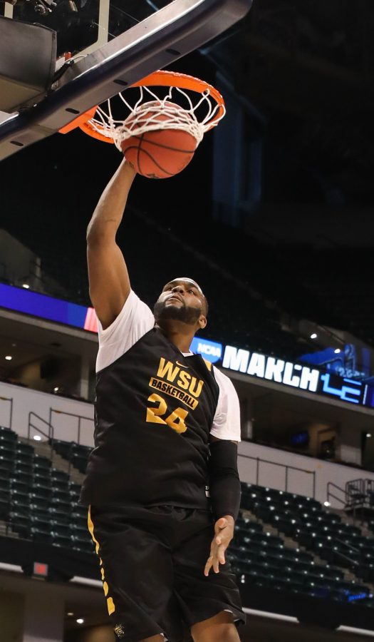 Wichita State center Shaquille Morris dunks during open practice on Thursday afternoon in Bankers Life Fieldhouse in Indianapolis. (Mar. 16, 2017)