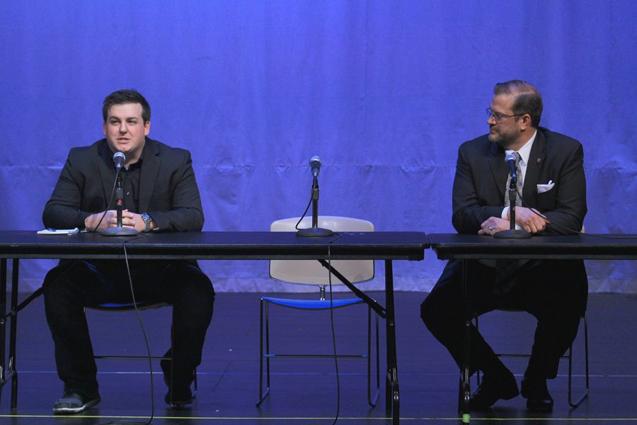Jordan Husted, campaign manager for Libertarian Chris Rockhold, and Democrat James Thompson participate in a forum for the 4th District Special Election candidates Wednesday in the CAC Theatre. The empty chair between them was for Republican Ron Estes, who did not attend the forum and did not send anyone in his stead.