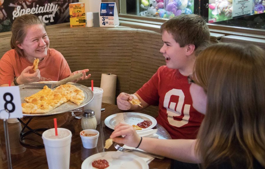 Lauren, Luke and Lindsay O’Neal (left to right) enjoy dinner with their parents at Knolla’s Pizza’s east location at Central and Oliver on Tuesday evening. Knolla’s Pizza first opened in Orlando, Florida in 1981 then came to Wichita in 1988.