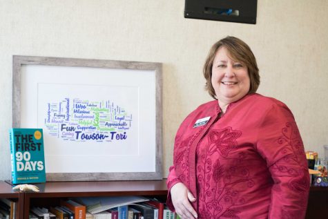 Teri Hall, Vice President of Student Affairs, poses with her Towson University Wordle.