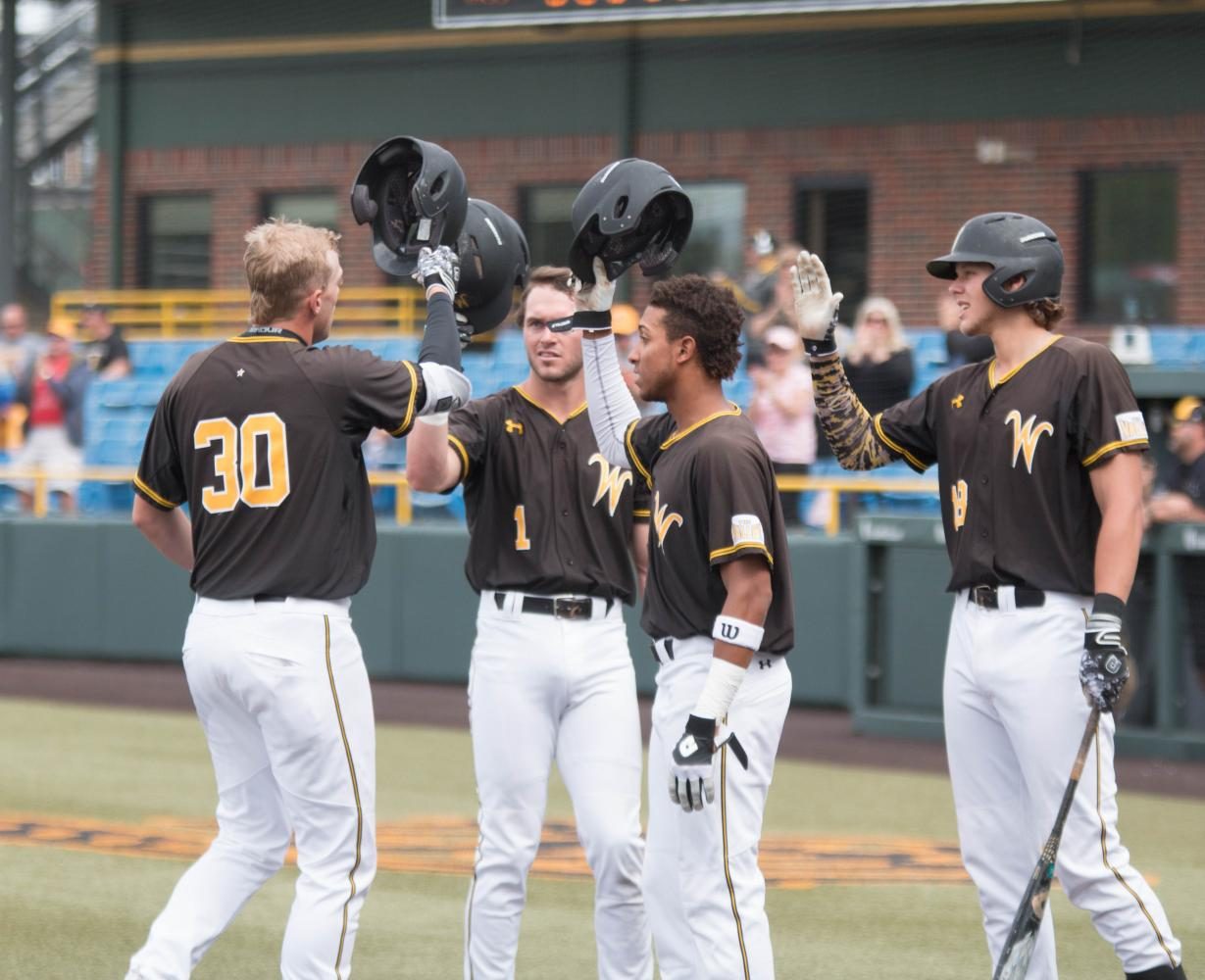 Wichita State outfielder Greyson Jenista is met by teammates Travis Young, Alex Jackson, and Alec Bohm at home plate after hitting a home run during the first game against Illinois State at Eck Stadium (April 28, 2017)