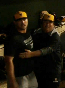 Director of Operations Scott Gurss leads graduate manager Zach Reding out of the dugout following a shoving match with WSU baseball players Dayton Dugas and Greyson Jenista. 