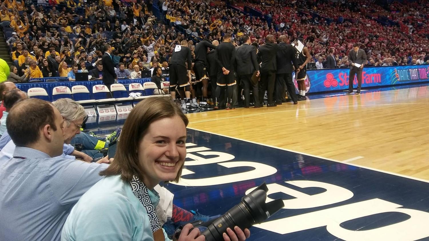Hannah Roberts sits courtside as she photographs Wichita State in the Missouri Valley Conference Tournament Championship game in St. Louis. (March 5, 2017)