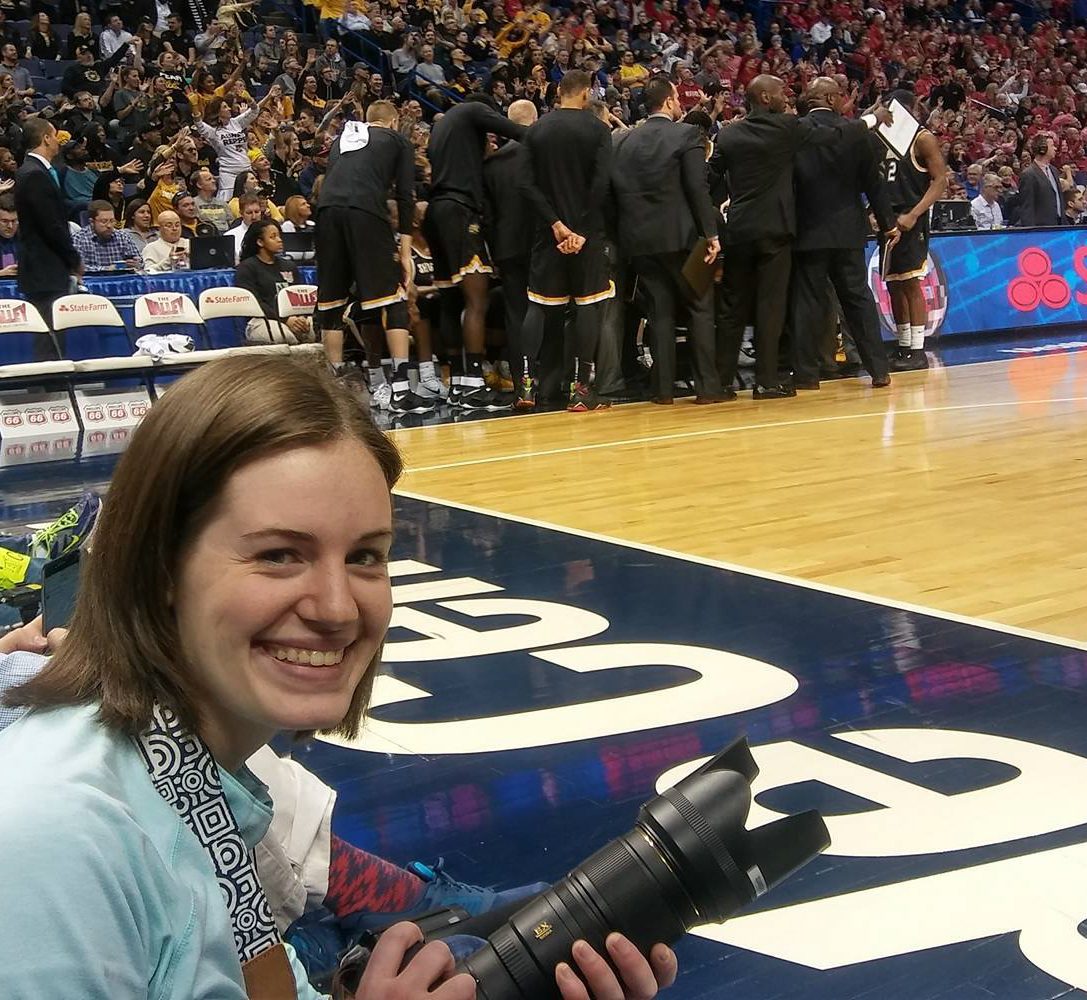 Hannah Roberts sits courtside as she photographs Wichita State in the Missouri Valley Conference Tournament Championship game in St. Louis. (March 5, 2017)
