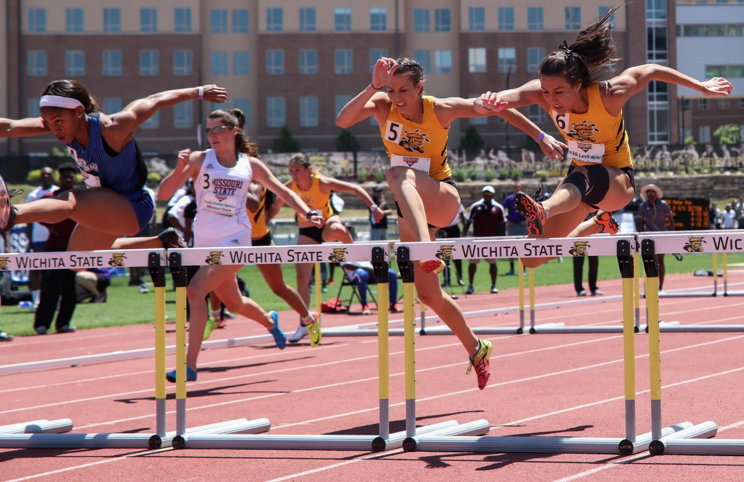 Nikki (6) and Taylor (5) Larch-Miller try to catch Mary Young in the 100 meter hurdles Sunday at the Missouri Valley Conference Outdoor Track and Field Championship. Young placed first followed by Nikki then Taylor. (May 14, 2017)