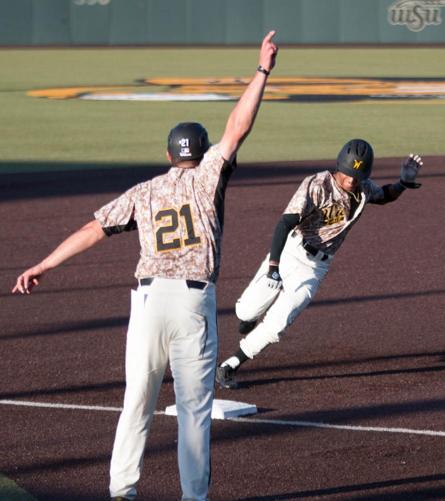 Wichita State freshman Alex Jackson rounds third base before scoring against Evansville at Eck Stadium Friday evening.