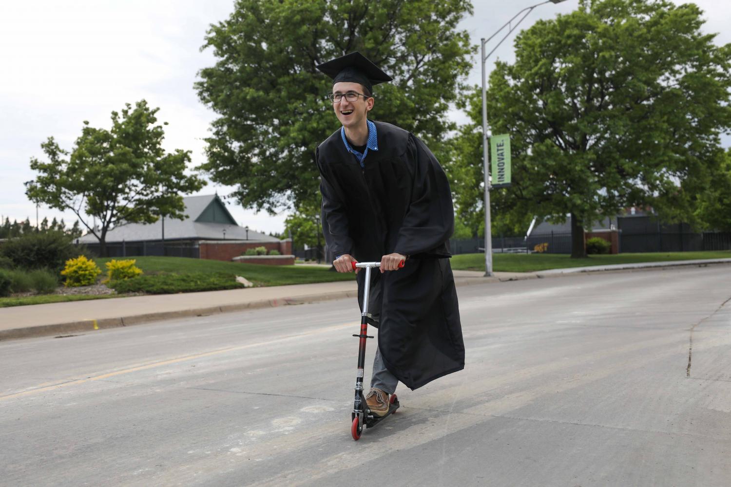 FILE PHOTO: Wichita State student Evan Pflugradt blissfully scoots his way into graduation.