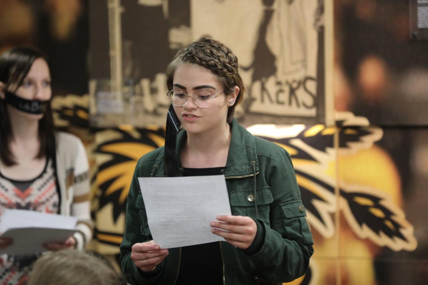 Sandra Carlo reads a list of demands of Student Body President Paige Hungate. 