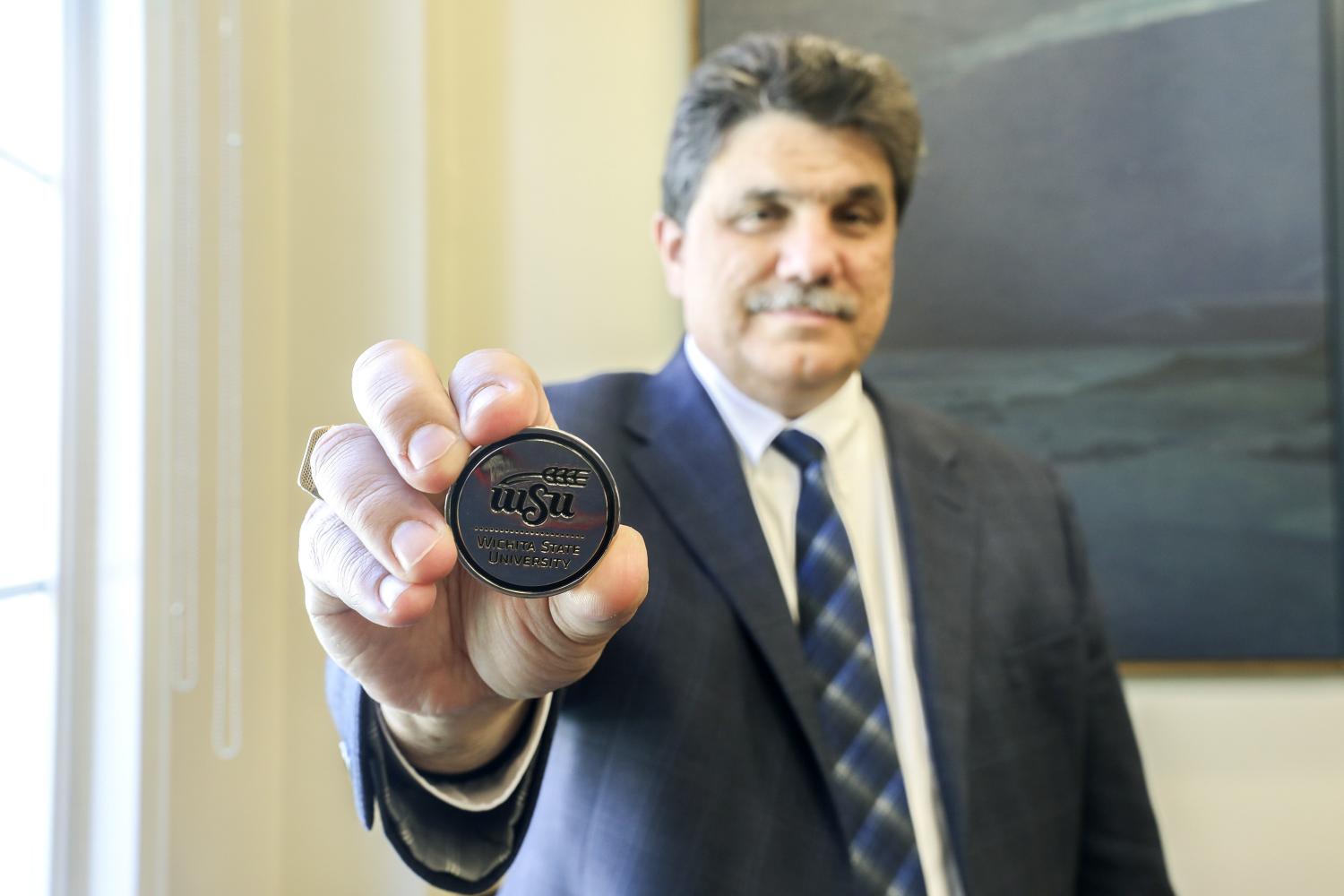 WSU Provost and Senior Vice President Anthony Vizzini holds one of the challenge coins given to graduates during the
ceremony. Dr. Vizzini said he always carries one in his pocket.