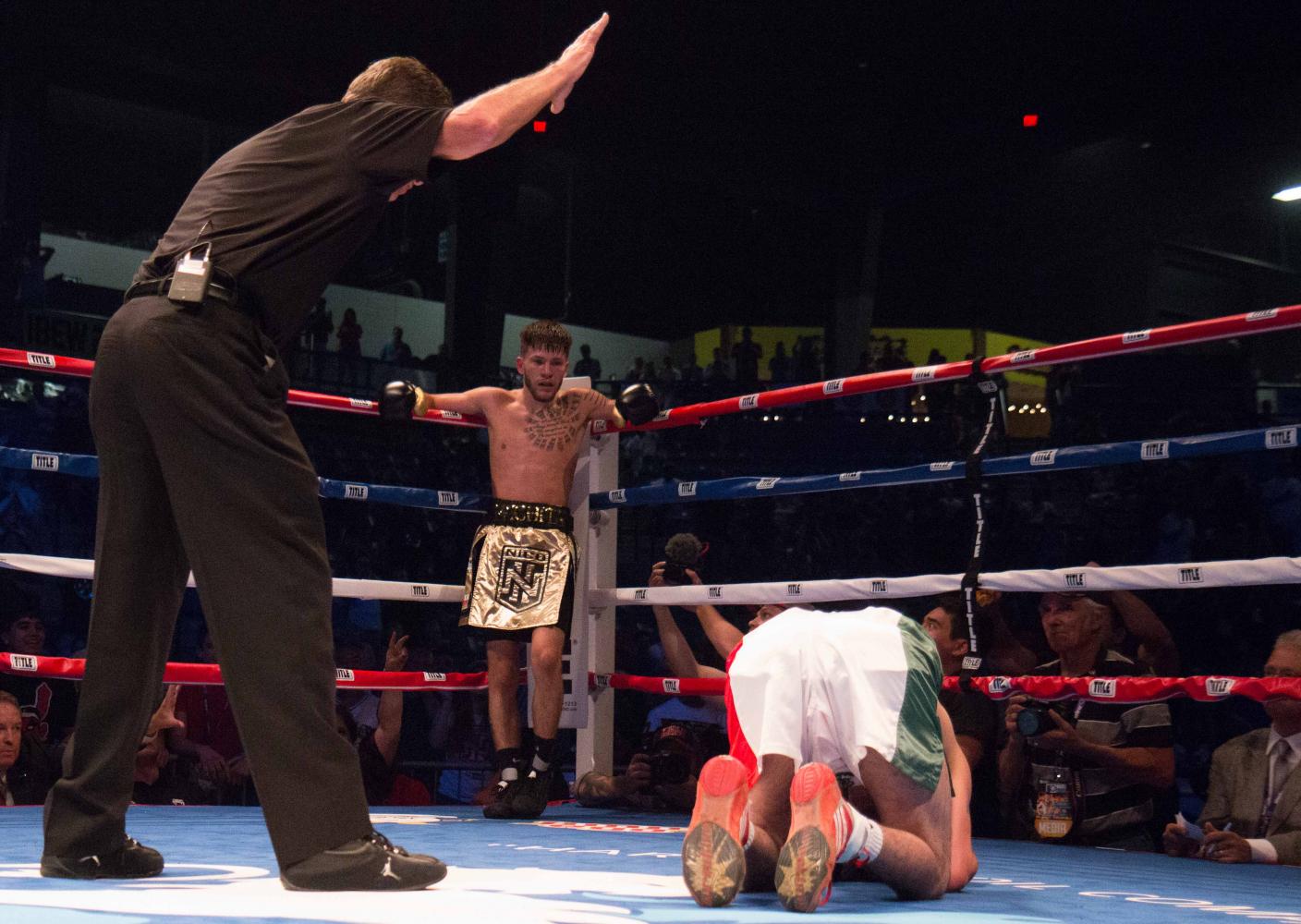 The referee counts off the seconds as Jose Rodriguez remains on the ground in the third round. Nico Hernandez won the Flyweight event by knockout at the KO Night Boxing held at Harman Arena in Park City. (June 17, 2017)