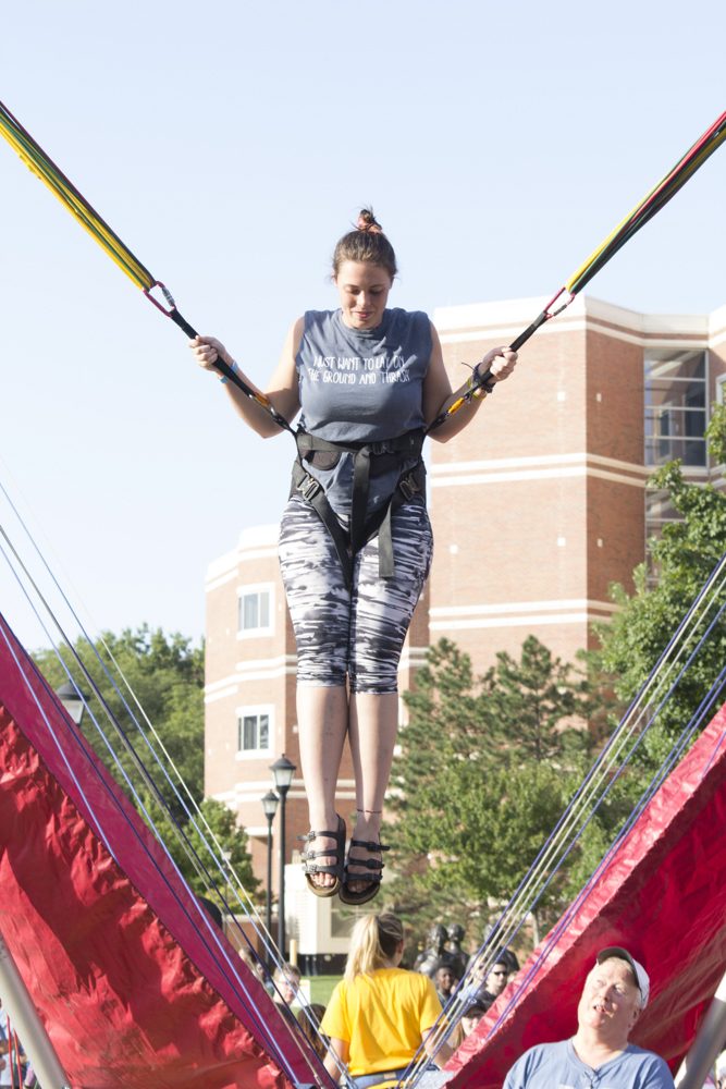 Kat Dorenbach jumps on bungee trampoline during the Back to School Bash.