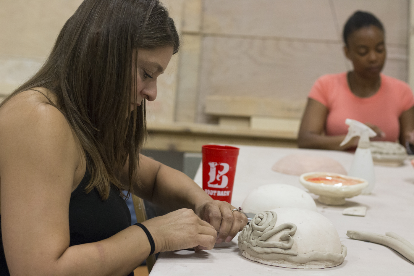 Wichita State alumni, Kristin Dexter, makes a bowl during the Empty Bowls event in Henrion Hall.