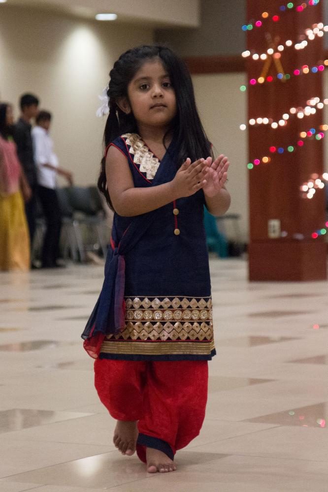 A child dances during the Garba Night. 