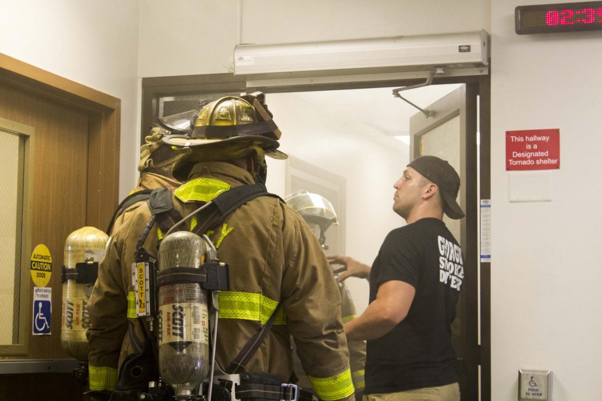 Wichita Fire Instructor Jared Case works with students to advance hoselines. 