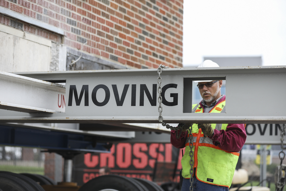 Monroe Becker, owner of Unruh House Moving Inc. prepares the trailer with original Pizza Hut building as its moved to its permanent home on Wichita State’s campus. (Sept. 18, 2017)