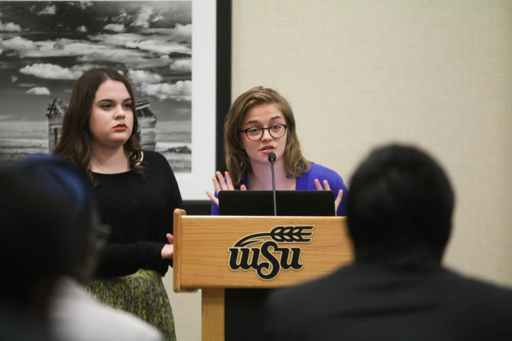 Xan Matteck and Shelby Rowell describe a bill they propose at the SGA meeting on Oct. 4.