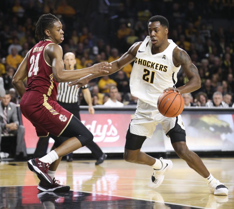 Wichita State Shockers forward Darral Willis Jr. attempts to break around Charleston Cougars forward Jaylen McManus during the game in Koch arena.