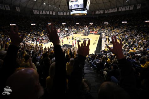 Wichita State fans holds up the shockers during the exhibition opener against Henderson State in Koch Arena.