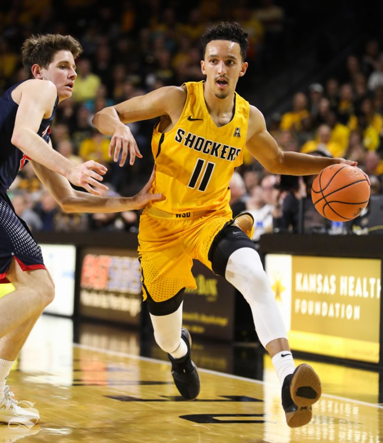 Wichita State Shockers guard Landry Shamet  breaks around a Newman defender during the charity exhibition game in Koch Arena.