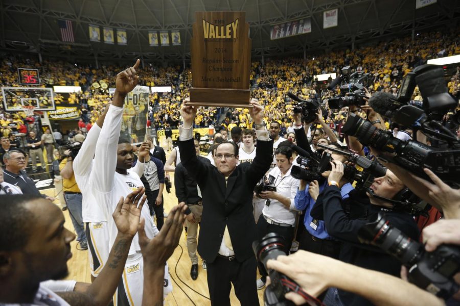 Wichita State head coach Gregg Marshall holds up the 2014 The Valley regular season trophy. 