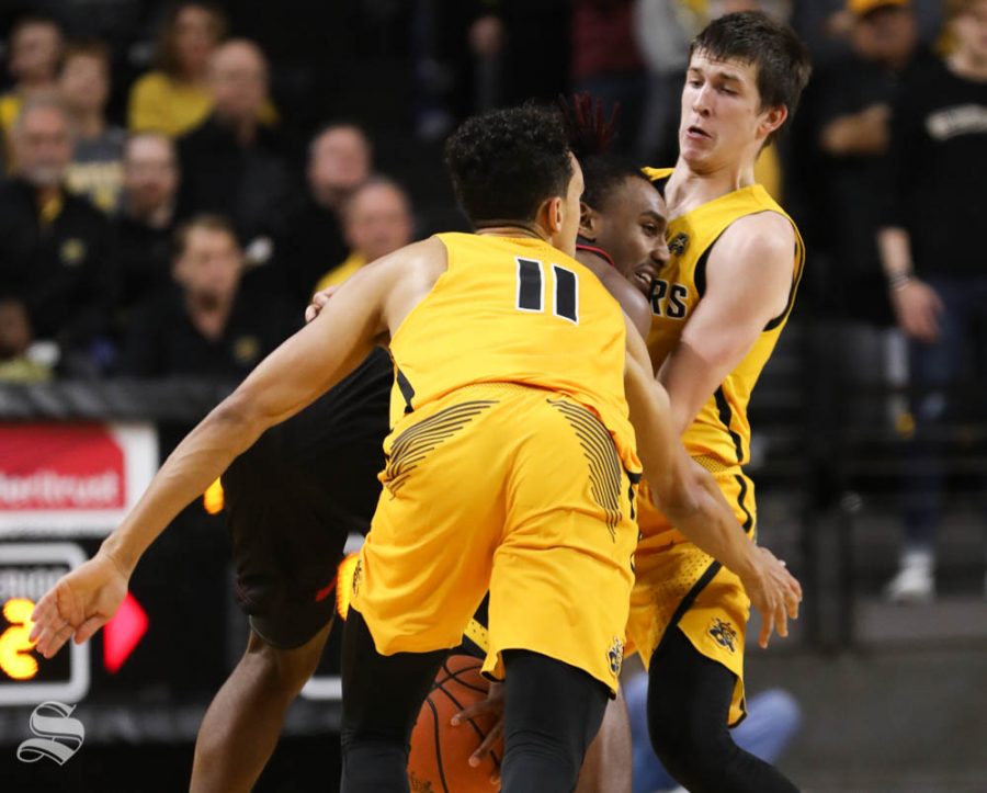 Wichita State guard Austin Reaves and Landry Shamet guard Arkansas State guard Deven Simms during the second half in Koch arena
