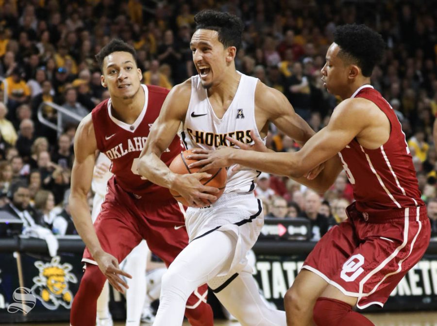 Wichita State guard Landry Shamet drives to the basket against Oklahoma center Jamuni McNeace and Oklahoma guard Jordan Shepherd during the second half in Intrust Bank Arena.