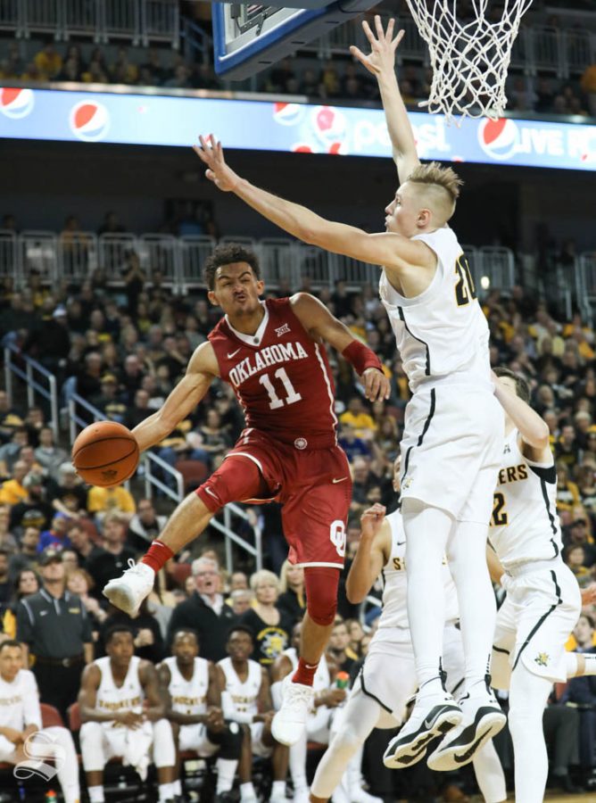 Oklahoma guard Trae Young pass around Wichita State center Rauno Nurger during the first half in Intrust Bank Arena.