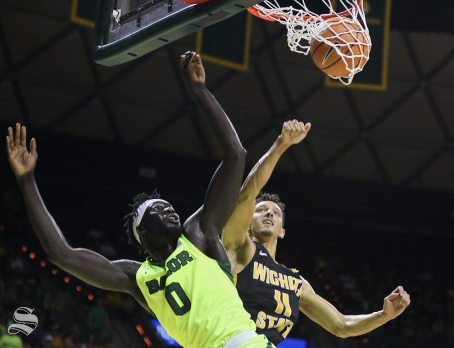 Baylor forward Jo Lual-Acuil Jr. scores on Wichita State guard Landry Shamet in the second half in Ferrel Center, in Waco, Texas.