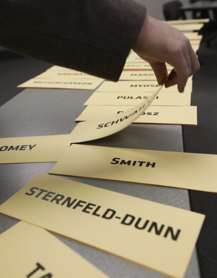 Name plates for faculty senators are laid out on a table before the start of a Faculty Senate meeting in January.