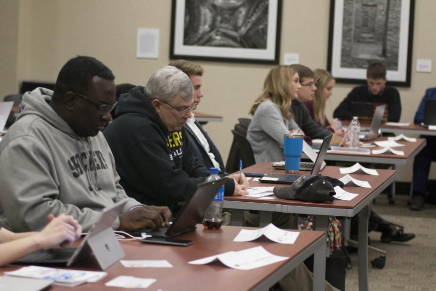 Senators listen as officer reports are given Wednesday evening during the SGA meeting. 