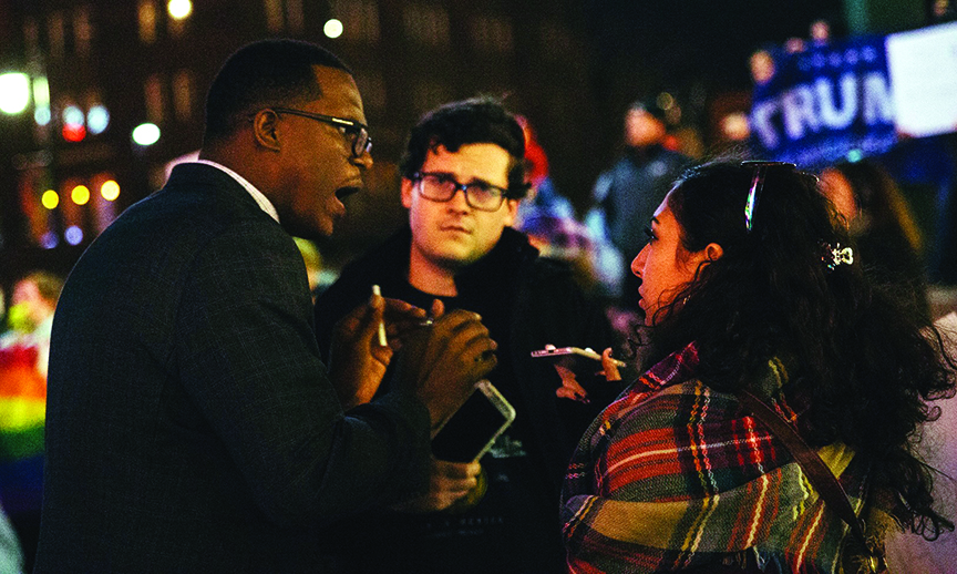 Former Sunflower reporter Nathan Davis, center, and Jenna Farhat speak to Djuan Wash during an anti-Trump rally before Davis death in Febuary of 2017.
