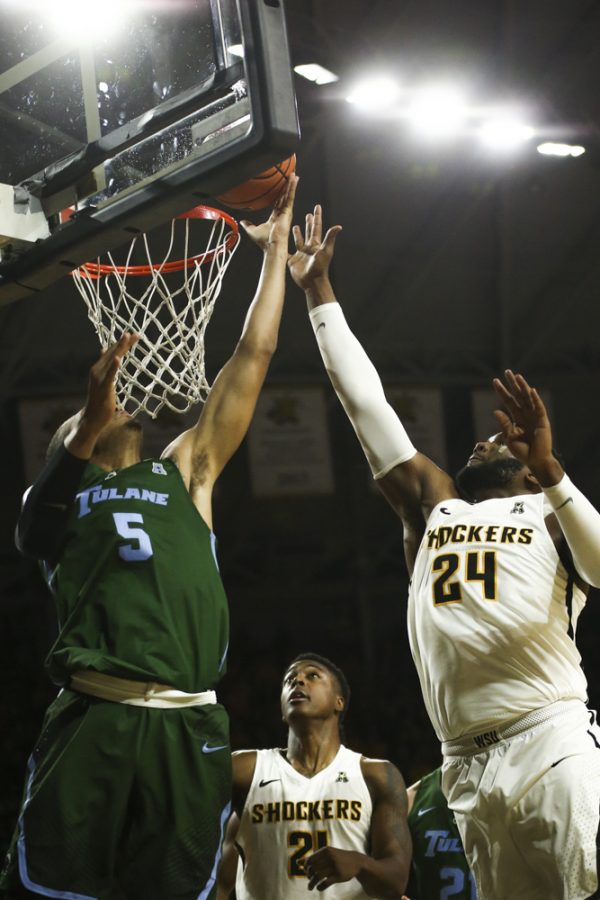 Tulane guard Riley Conroy shoots over Wichita State forward Darral Willis Jr. and center Shaquille Morris during the second half at Koch Arena.