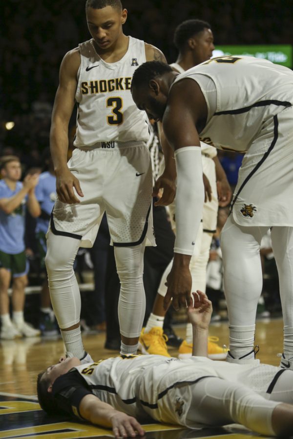Wichita State center Shaquille Morris helps up guard Austin Reaves during the second half at Koch Arena.