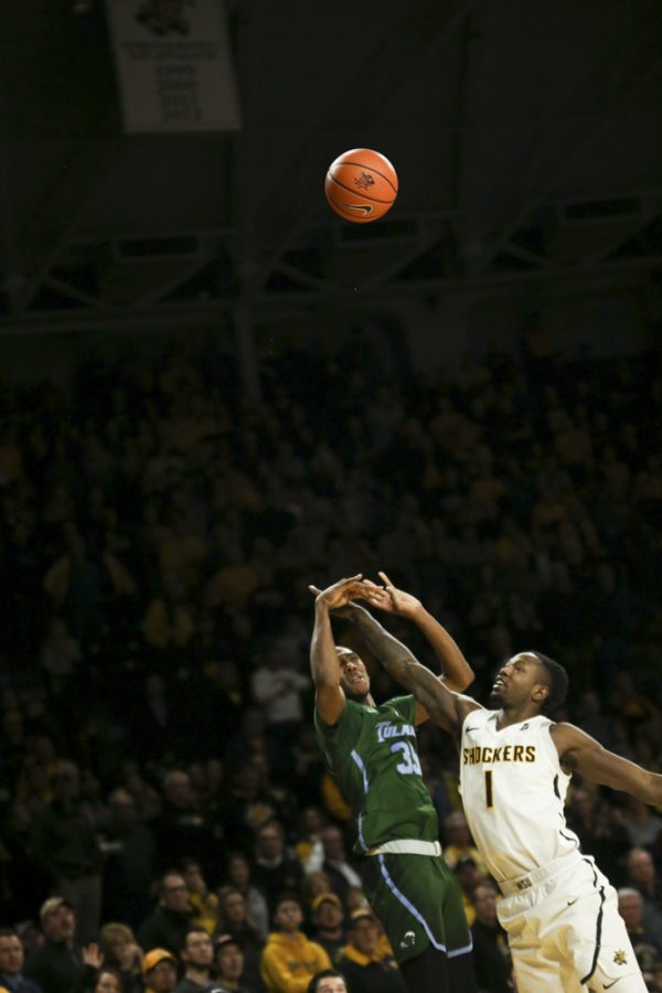 Tulane guard Melvin Frazier and Wichita State forward Zach Brown fight for the ball during the second half at Koch Arena.