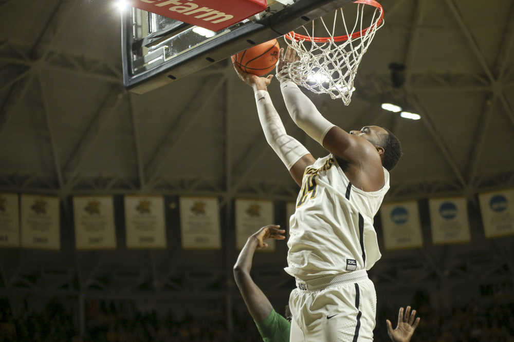 Wichita State center Shaquille Morris shoots against Tulane Green Wave defender during the first half at Koch Arena.