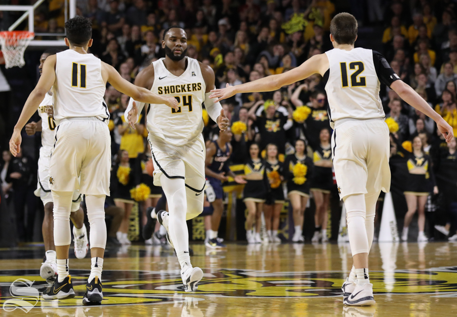 Wichita State center Shaquille Morris high fives Landry Shamet and Austin Reaves Saturday in Koch Arena.