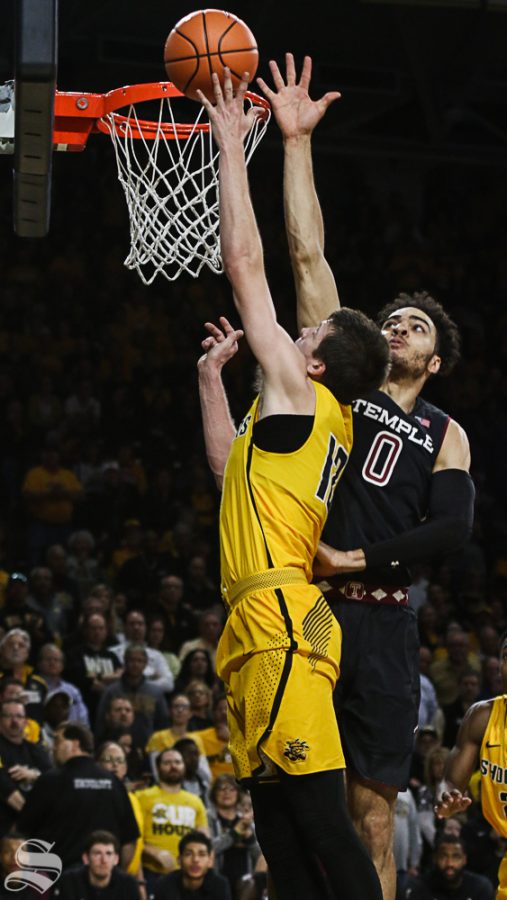 Wichita State guard Austin Reaves scores on Temple forward Obi Enechionyia during the first half at Koch Arena.