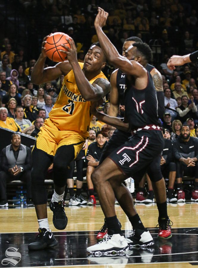 Wichita State forward Darral Willis Jr. gets fouled by Temple guard Josh Brown while shooting during the first half at Koch Arena.