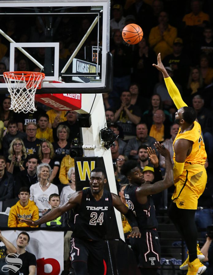 Wichita State center Shaquille Morris makes a lay-up over Temple forward DeVondre Perry and center Ernest Aflakpui  during the second half at Koch Arena.