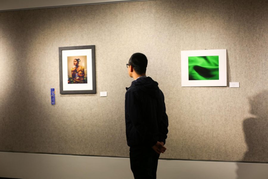 Students browse the Cadman Gallery during the reception of the 2018 Exposure Photography Awards.