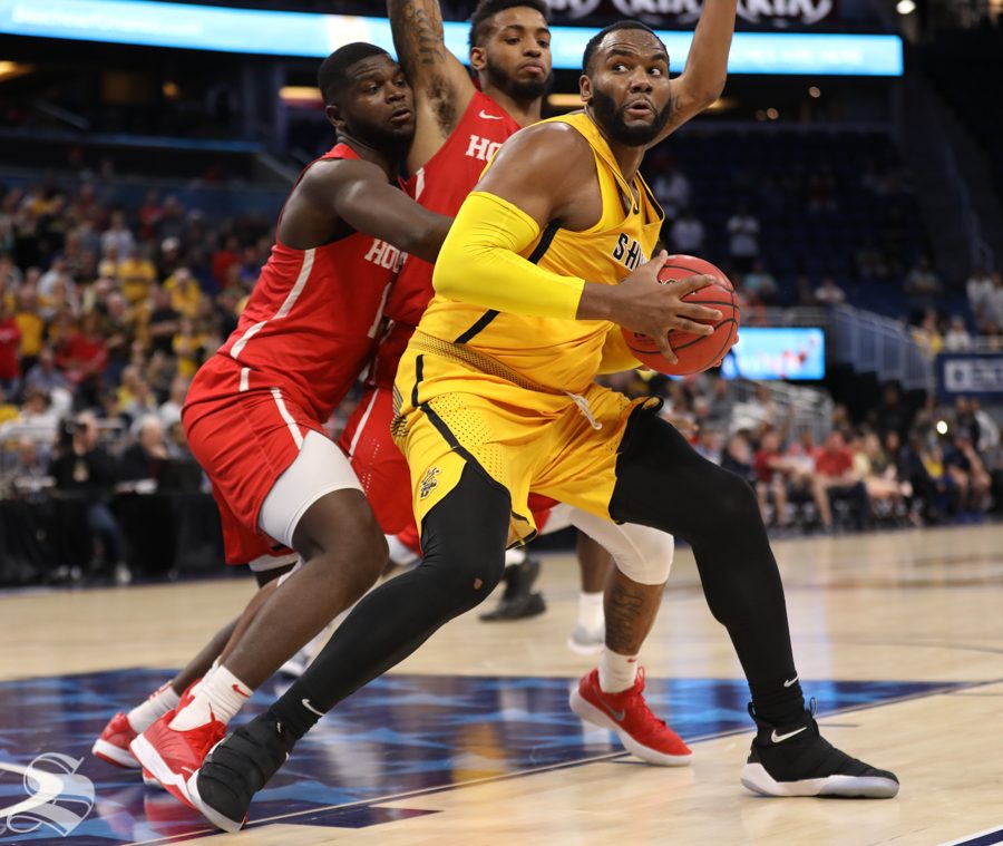 Wichita State center Shaquille Morris pivots around Houston defenders in the American Conference Tournament semifinals against Houston.