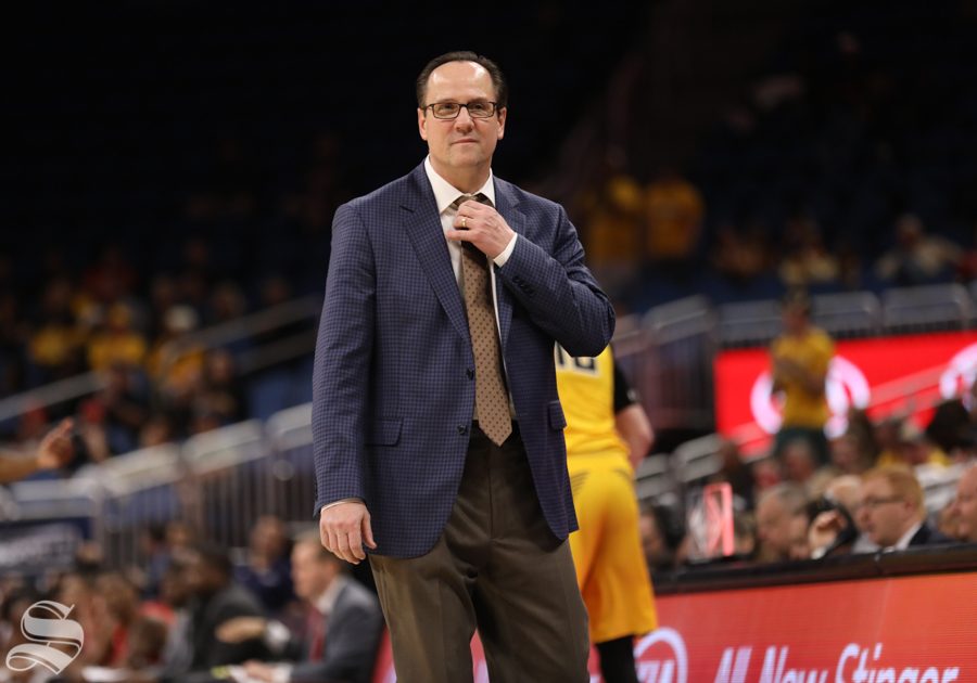 Wichita State head coach Gregg Marshall adjusts his tie during the American Conference Tournament semifinals against Houston.