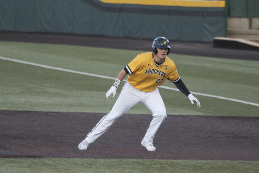 Wichita State Mason OBrien watches the pitch from first base during the game against the Sooners.