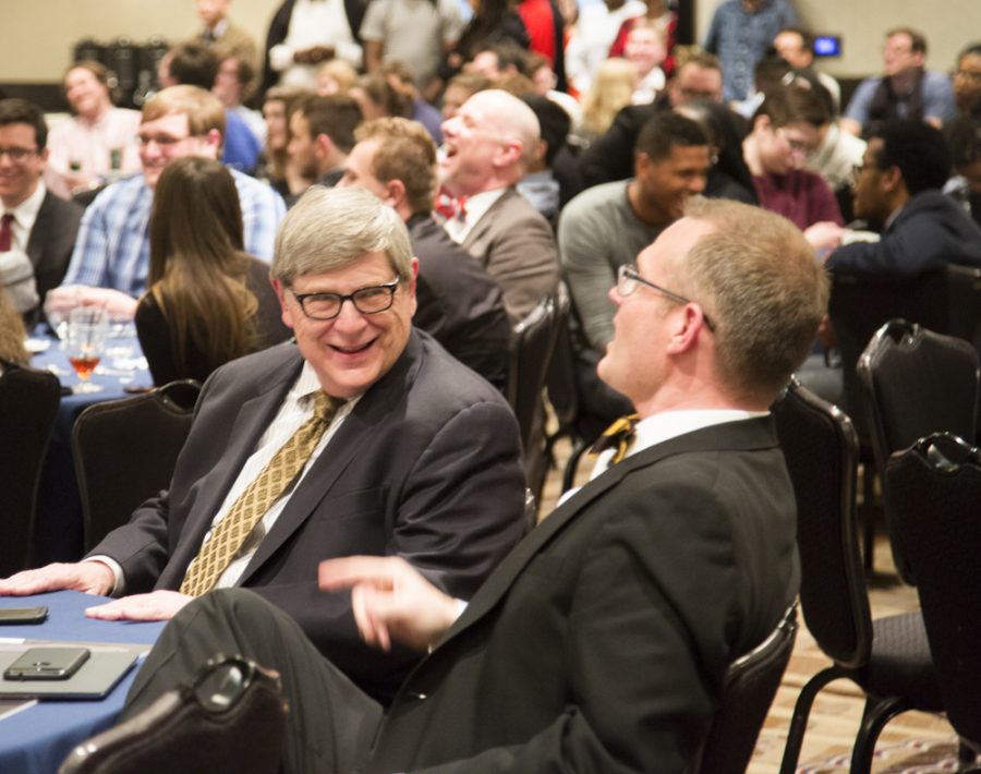 Lee Thompson (left), one of the debaters that won the National Debate Tournament for WSU 50 years ago, laughs with Jeff Jarman during the NDT award ceremony at the Marriott.