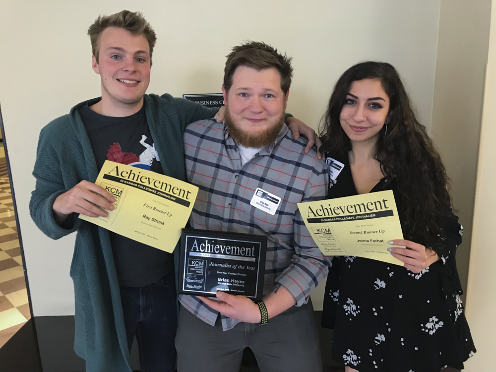 Ray Strunk, Brian Hayes, and Jenna Farhat who won second, first, and third, respectively, pose for a photo after winning the Kansas Collegiate Journalist of the Year competition.