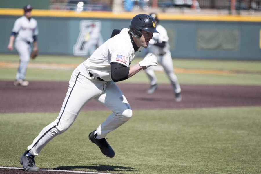 Wichita States Travis Young runs for home plate to score against UConn Sunday afternoon at Eck Stadium. 
