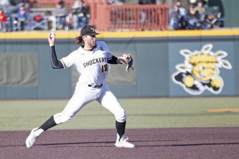 Wichita State junior Alec Bohm throws to first in a game against KU at Eck Stadium.