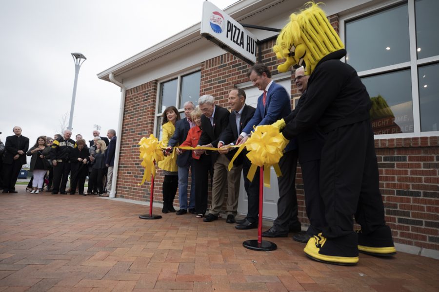Members of Pizza Hut and WSU cut the ribbon at the opening of the Pizza Hut Museum.